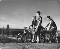 Three boys on bicycles watch bridge in process, February 1940 TPL 9506