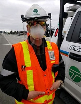 Richard Ostrander wears his personal protective equipment while assisting a driver on I-5 in Tacoma image
