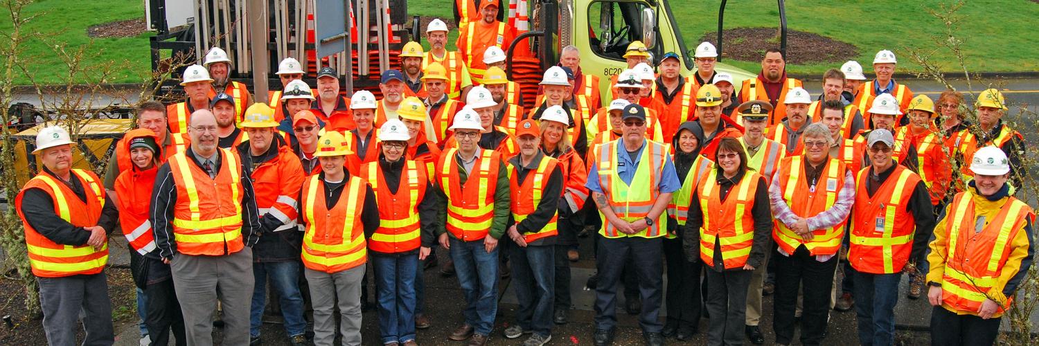 Group of WSDOT employees wearing orange vests and hard hats