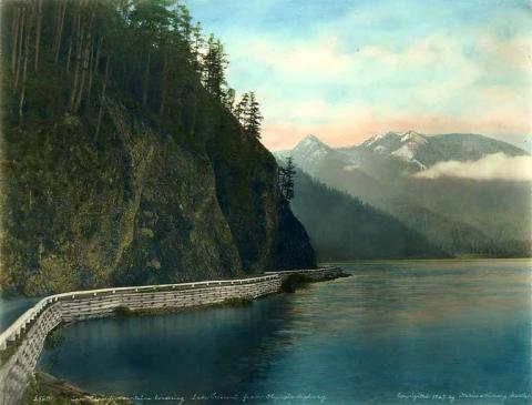Lake Crescent Highway and bridge with snow-capped mountains in background, ca 1927.