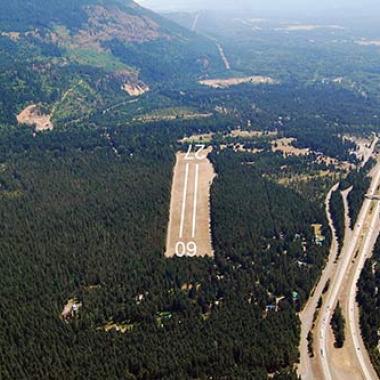 Easton State Airport runway surrounded by forest trees.