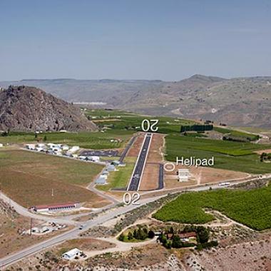 The runway at Lake Chelan airport surrounded by foothills. 