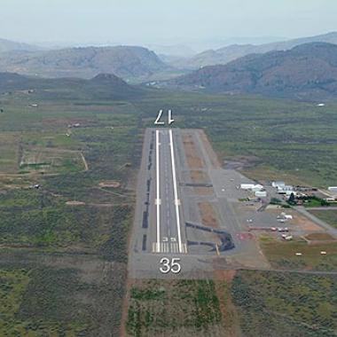 Runway at Omak airport with foothills in the distance. 