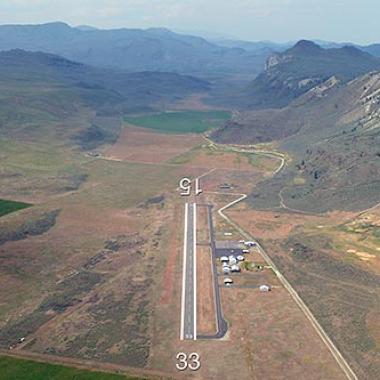 The runway at Tonasket Municipal airport surrounded by mountainous terrain. 