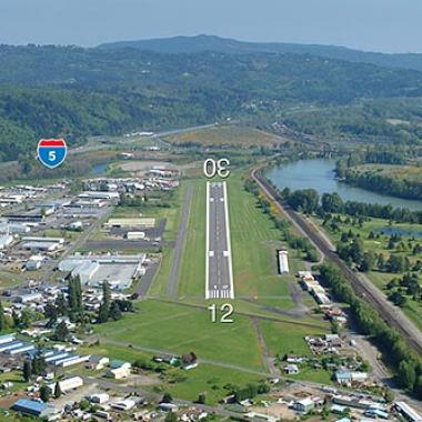 Kelso-Longview Airport runway located inbetween a city center and highway.
