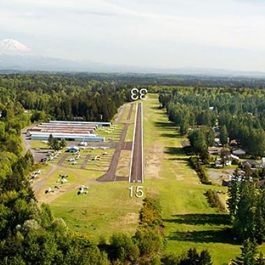 Norman Grier Field Airport Runway located in flat grasslands in the middle of a lot of trees and forests