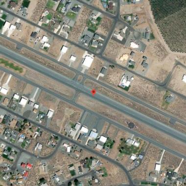 Desert Aire Airport runway located on flat grasslands.