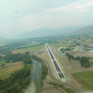 A photo of the Methow Valley airport runway stretching into the distance.