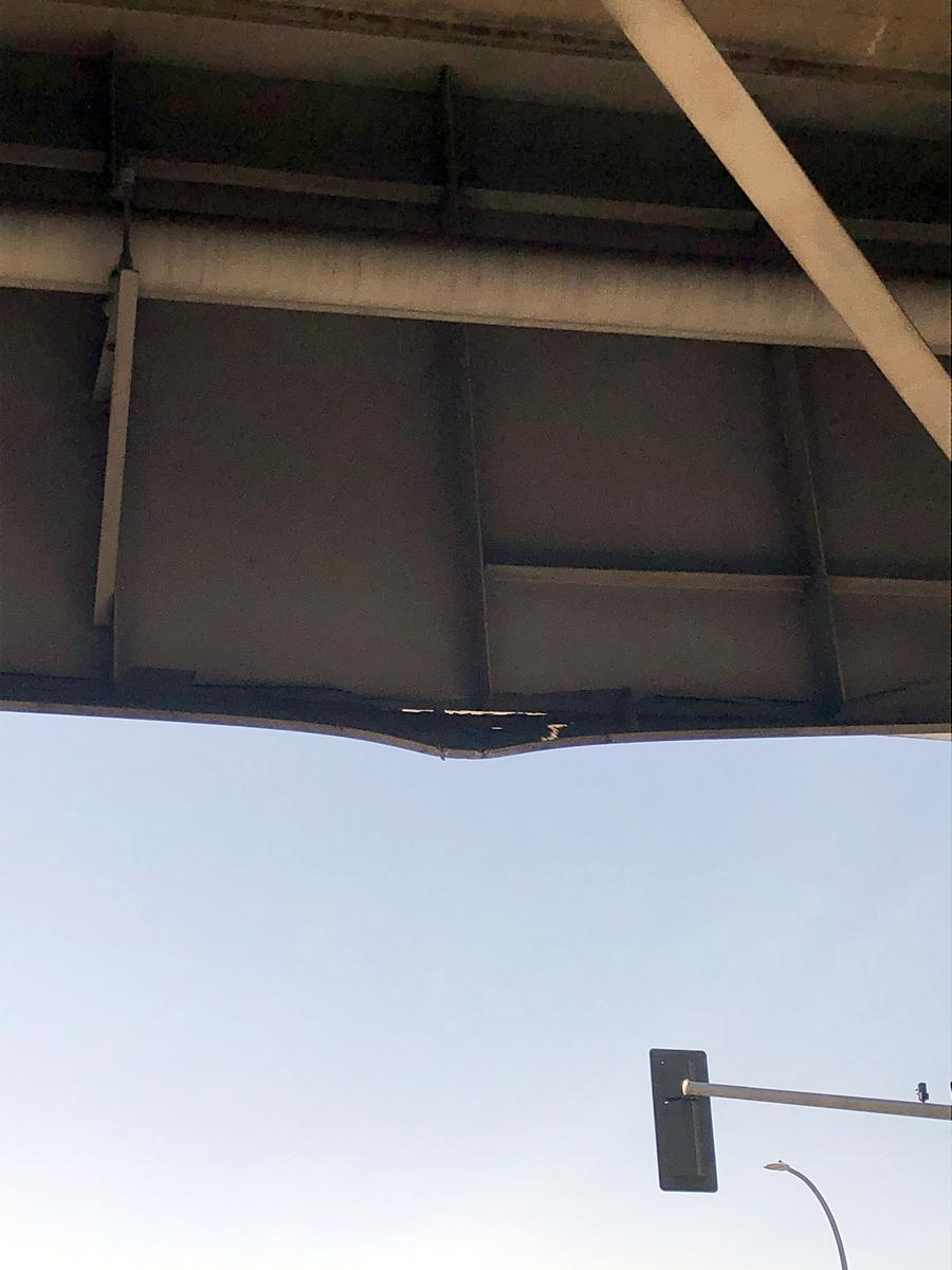 A photo showing damage to a steel girder that carries 142nd Place Southeast over Eastgate Way in Bellevue..