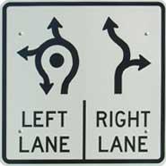Image of a roundabout lane choice sign with two lane options.  The left lane shows u-turn, left turn, and through movements.  The right lane shows through and right turn movements.