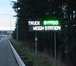 Bypass green light for transponder equipped trucks bypassing the weigh stations