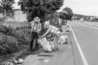 Adopt-A-Highway volunteer collect and bag litter along State Route 99 in King County.