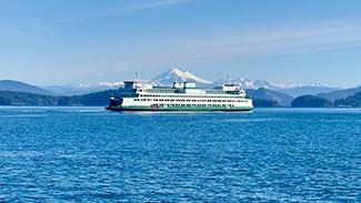 Ferry near San Juan Islands with mountains in the background