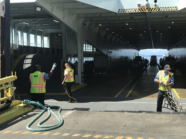 Photo of crewmembers working aboard a ferry