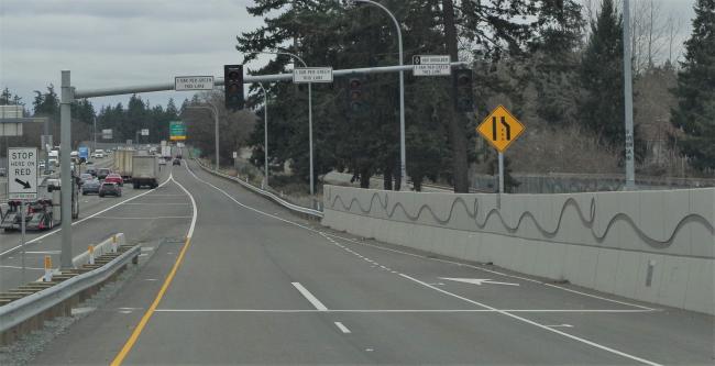 Image of a freeway on-ramp ramp meter signal with two general lanes and a metered HOV shoulder.