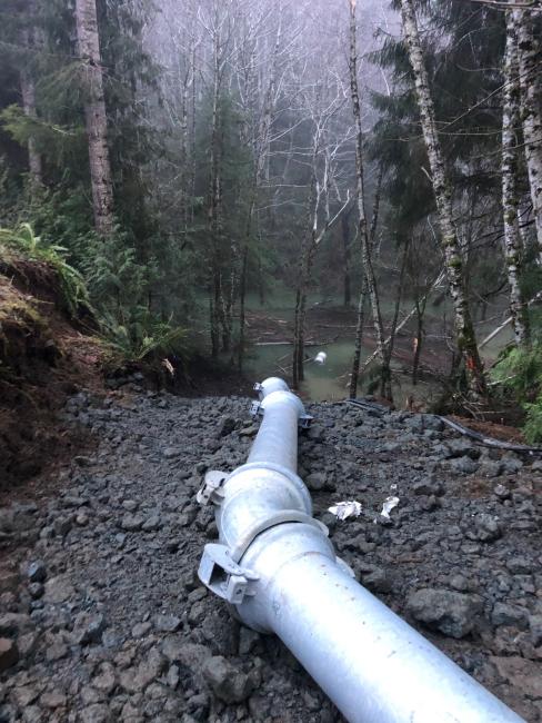 Photo of temporary pumping operations near flooded culvert site.