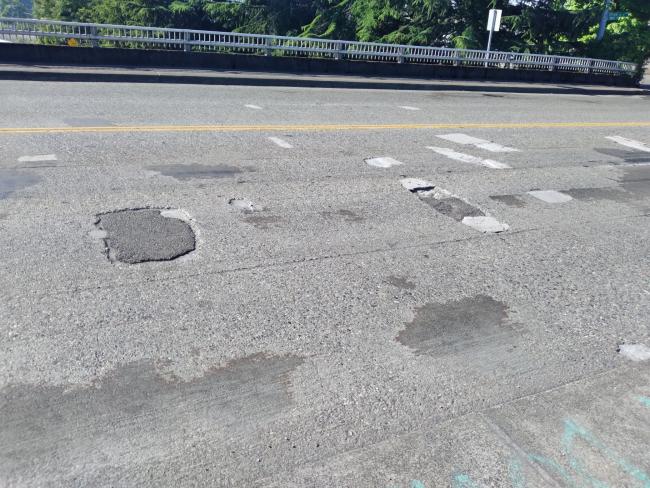 A photo of the potholes and patches on the I-5 Albro Street overpass