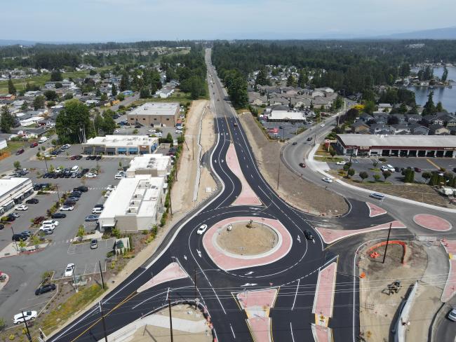 Aerial view of new SR 9 roundabout at Vernon Road in Lake Stevens. Two cars navigate the roundabout.
