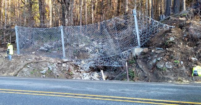 Debris fence stretches across a stream channel along US 2 near Skykomish.