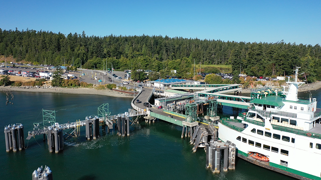 Aerial view of Samish docked at Anacortes terminal with vehicles disembarking the vessel