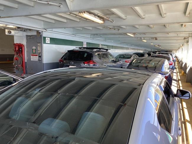 Several vehicles on the car deck of a ferry