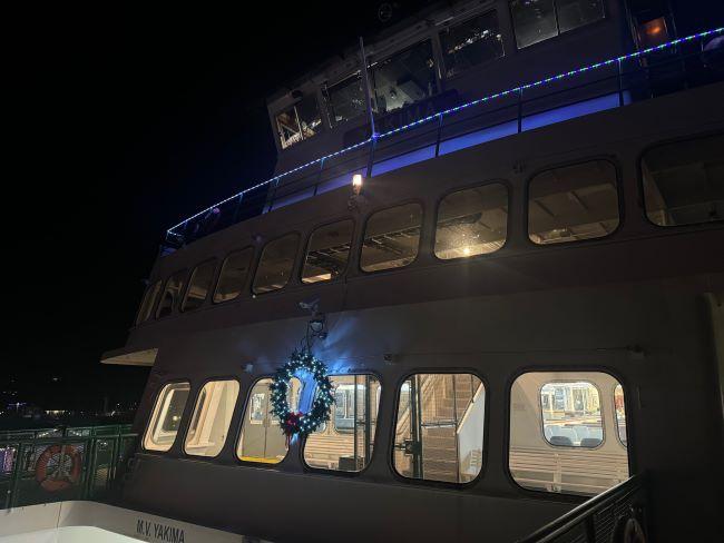 Close-up view of the ferry Yakima at night decorated with lights and a wreath